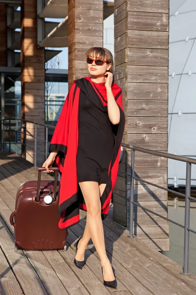 Beautiful businesswoman with suitcase — Stock Photo, Image