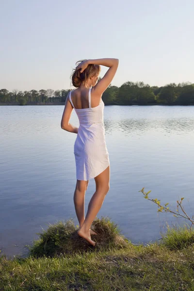 Roztomilá mladá žena na pozadí vody — Stock fotografie
