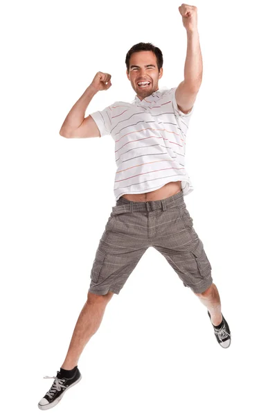 Junger glücklicher Mann springt auf einem weißen — Stockfoto