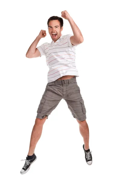 Молодой счастливый человек прыгает на белом Стоковое Фото