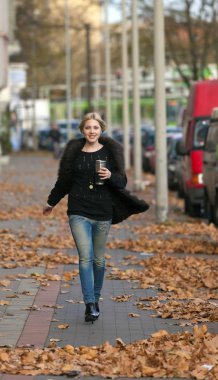 Woman walking on the street clipart