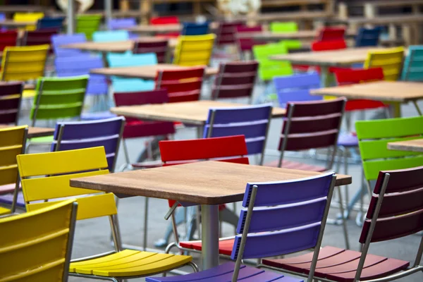 stock image Tables and coloured chairs in a street cafe