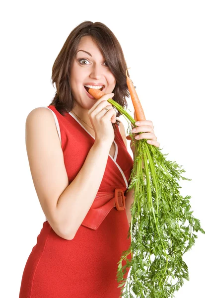 Mujer embarazada con zanahorias frescas — Foto de Stock