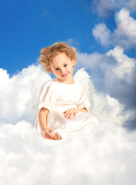 Little girl with fairy wings lies on a cloud — Stock Photo, Image