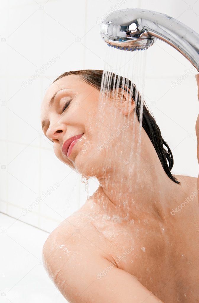 Females taking a shower with clothes on