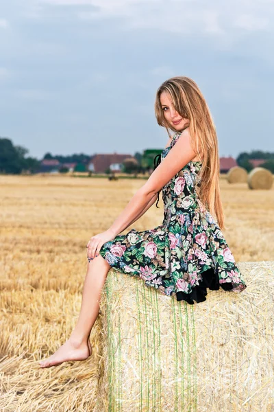 stock image Woman sitting on hay bale