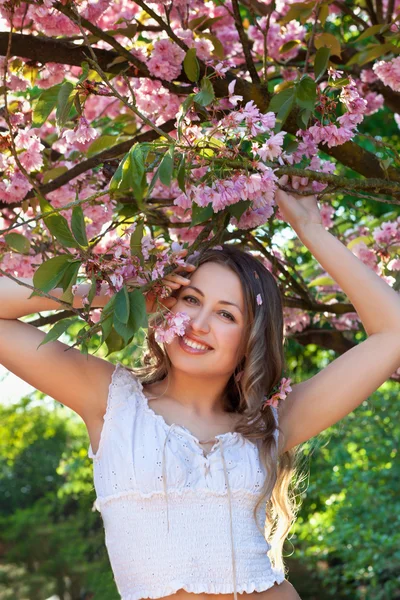 stock image Woman among a spring blossom