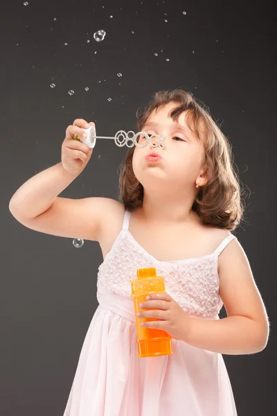 Little girl blowing soap bubbles — Stock Photo, Image