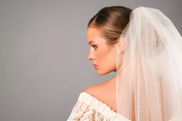 Portrait of beautiful bride under a veil in studio — Stock Photo, Image