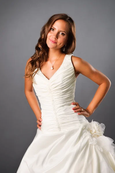 Beautiful bride wearing wedding dress in studio — Stock Photo, Image