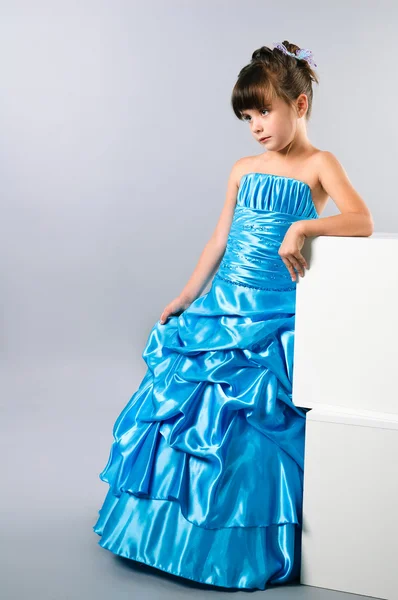 A cute girl posing in a prom dress in studio — Stock Photo, Image