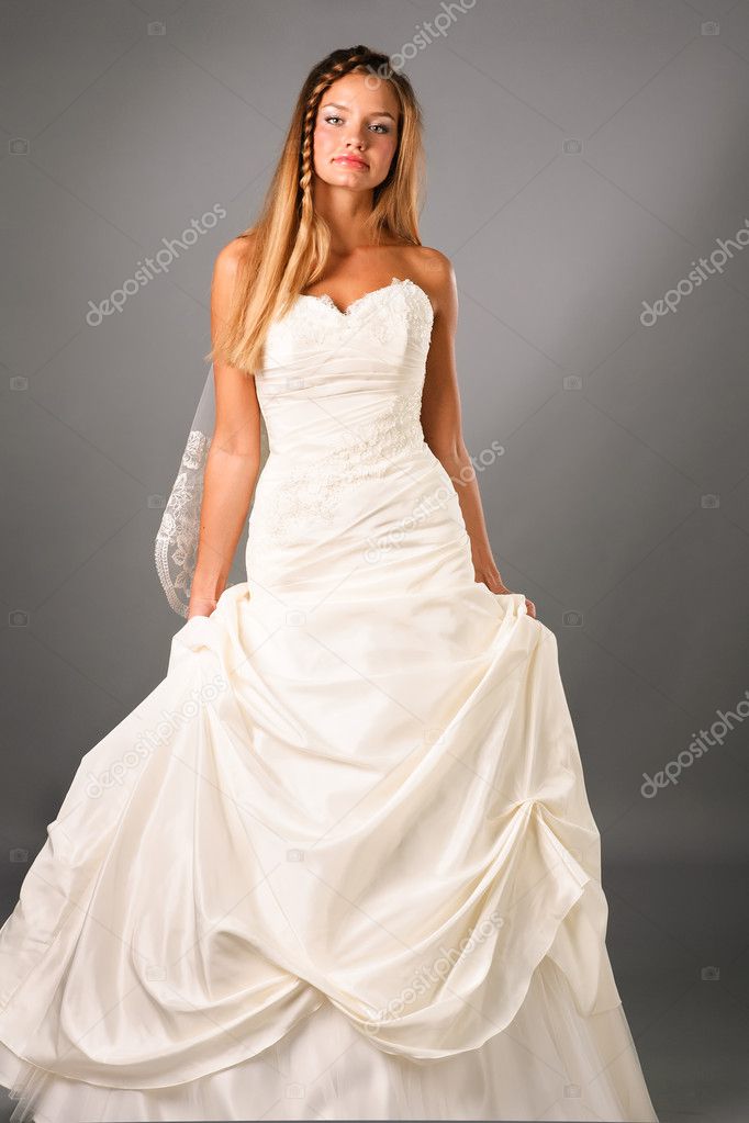 Beautiful bride wearing wedding dress in studio