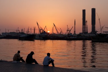 Workers rest in the port Sharjah. clipart