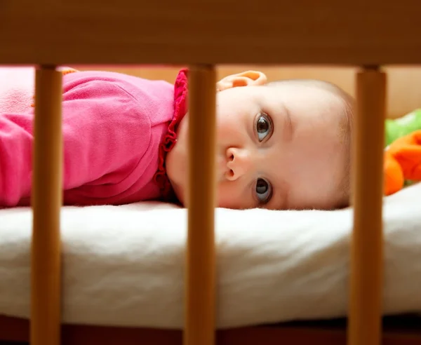 Baby girl in her bed — Stock Photo, Image