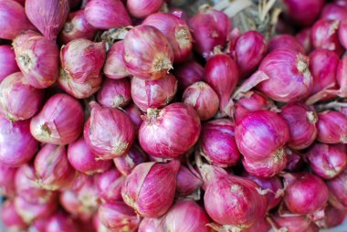 Fresh red onions in market clipart