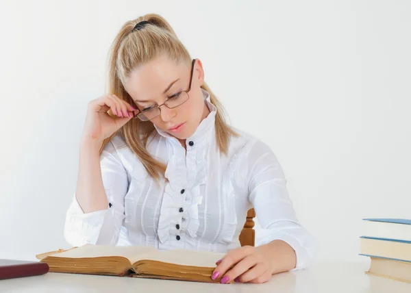 Menina bonita com óculos lendo um livro — Fotografia de Stock