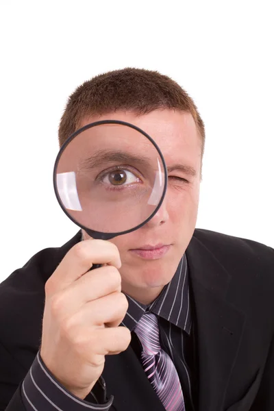 Close-up man looking through magnifying glass — Stock Photo, Image