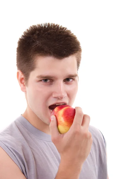 Jonge man die appel eet — Stockfoto