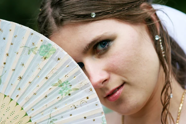 The bride in a white dress with a fan — Stock Photo, Image