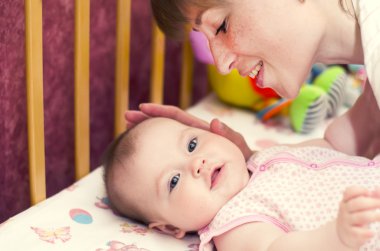 Portrait of happy mother with joyful baby clipart