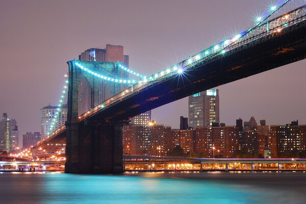 New York City Manhattan with Brooklyn bridge at night.