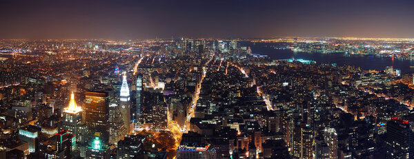 New York City aerial view panorama with Manhattan skyline at night.