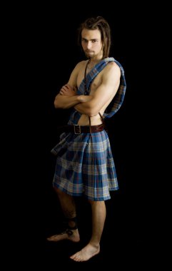 Young man dressed in a scottish kilt clipart