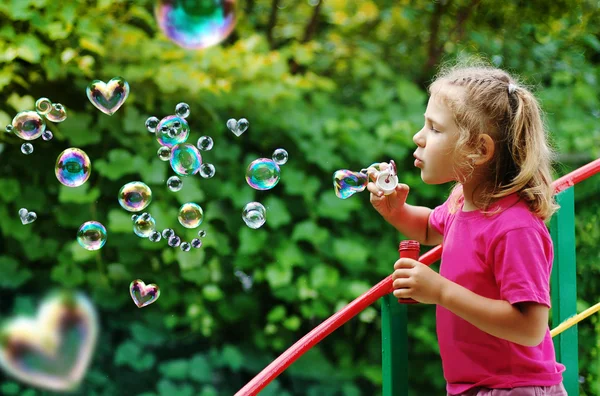 Stock image Little girl blowing interesting bubbles