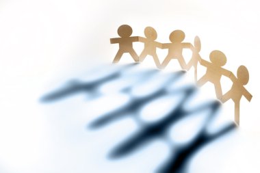 Six paperchain persons holding hands casting shadows clipart