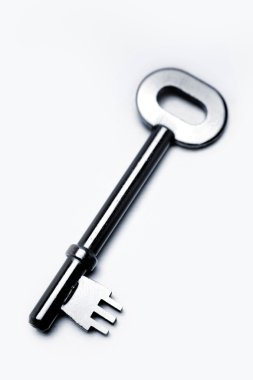 Closeup of old door key on plain background clipart