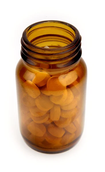 Open bottle of pills on plain background — Stock Photo, Image