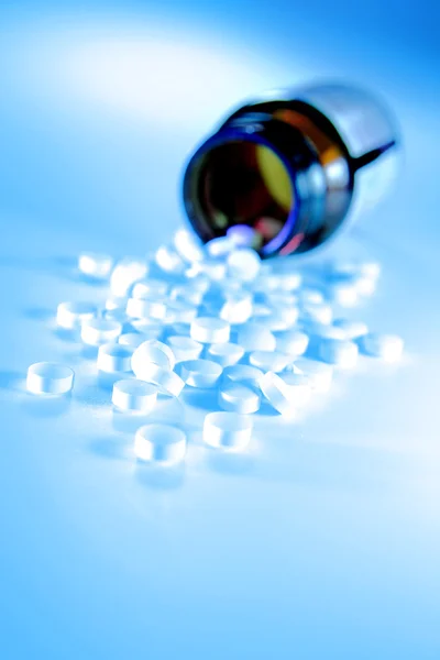 Bunch of pills spilling out of bottle — Stock Photo, Image