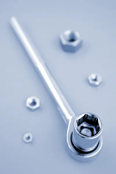 Wrench and nuts together, copy space — Stock Photo, Image