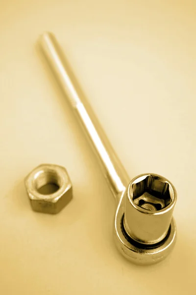 Ratchet wrench and nut still life — Stock Photo, Image