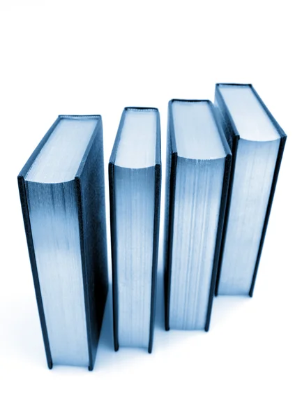 Cuatro libros aislados sobre fondo liso —  Fotos de Stock