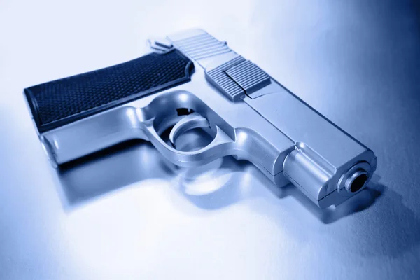 Closeup of handgun, studio shot, blue tone — Stock Photo, Image