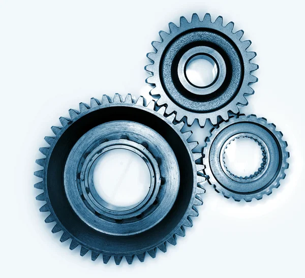 Three gears meshing together on plain background — Stock Photo, Image