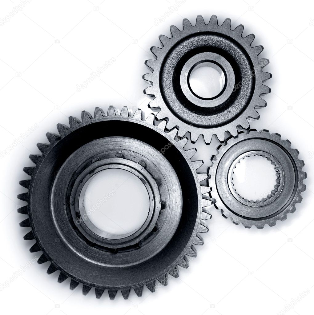 Three gears meshing together on plain background