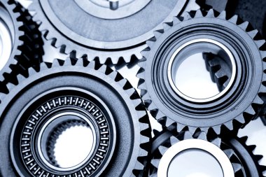 Closeup of steel gears meshing together clipart