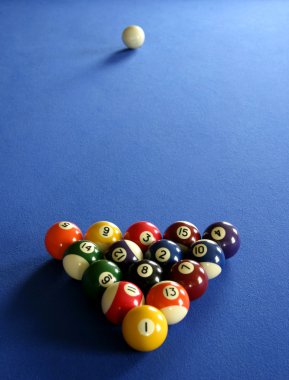 Pool balls on blue pool table clipart