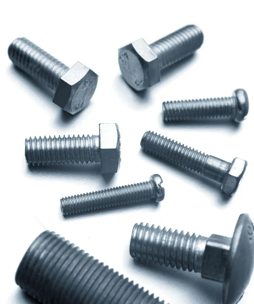 Bolts resting on a plain background — Stock Photo, Image