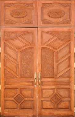 Crafted wood door at Buddish temple in Thailand clipart