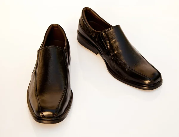 Black geniune leather businessmen 's shoes on white — стоковое фото