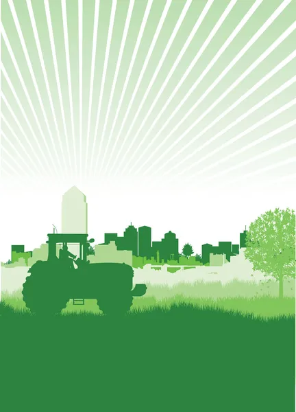 Traktor i ett fält framför en stadsbild — Stockfoto