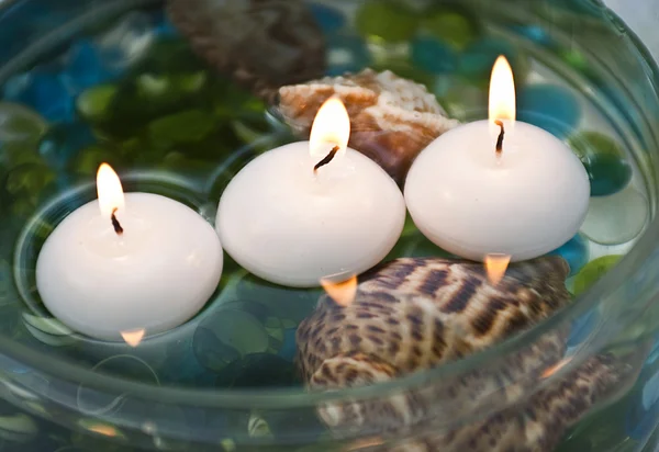 stock image Three burning candles and shell