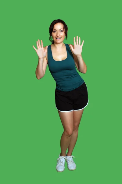 Krásná brunetka s fitness oblečení izolované na zelené — Stock fotografie