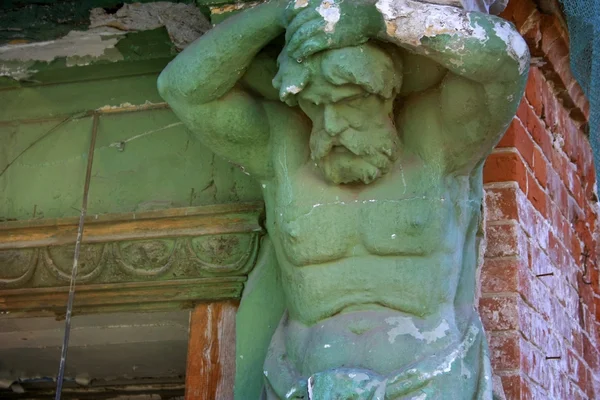 Статуя - чоловіча фігура тримає стіну старої будівлі — стокове фото