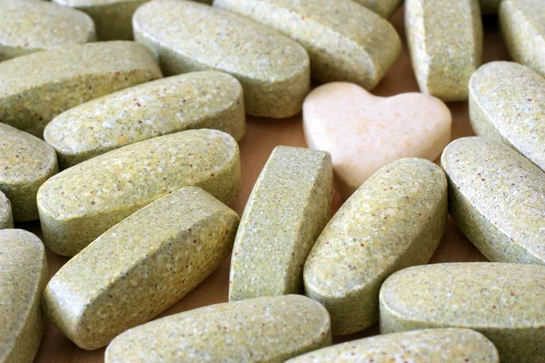 Różowe tabletki tabletki kolor piasku — Zdjęcie stockowe