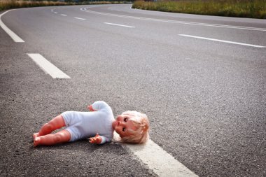 Doll leave on a highway lane clipart