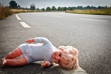 Doll leave on a highway lane clipart